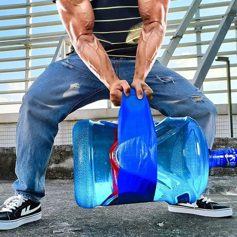 Person lifting a large blue water container using a handle outdoors, wearing casual jeans and sneakers in a dynamic pose.