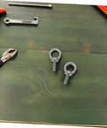 Heavy Duty Stainless Steel Eye Bolts M6x20 With Extended Threads For Serious Lifting And Rigging, Corrosion Resistant Eye Bolts For Industrial, Marine, And Home Use, Built Tough For Chains, Hooks, And Hardware, two M6 eye bolts on wood