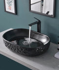 Matte Black Oval Vessel Sink 23.5 By 15.7 Inches, Ceramic Countertop Bathroom Basin With Pop Up Drain in modern bathroom setting