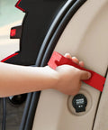 Hand holding a red nylon pry tool from the Snag These Dope 5 Piece Nylon Auto Trim Removal Tools For Your Ride set, used on car interior.