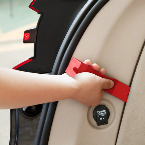 Hand holding a red nylon pry tool from the Snag These Dope 5 Piece Nylon Auto Trim Removal Tools For Your Ride set, used on car interior.