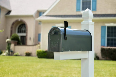 Edson Medium Capacity Galvanized Steel Post Mount Mailbox with Built to Last Rust-Proof Build in front yard