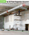 Top Notch Upgraded 360 Degree Laser Level With Electric Fine Adjustment Rotating Base Remote Control Rechargeable Self Leveling High Accuracy 1/13 Inch Pulse Mode For Precise DIY And Pro Projects in use for precise ceiling alignment in an industrial setting with scaffolding and ductwork.
