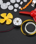 Plastic Crown Gear Set For DIY Robots And Toys, Motor Gear Kit with pulleys, plastic gears, belts, and motor on black background