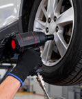 Heavy Duty 1/2 Inch Air Impact Wrench With Killer 1200 Ft Lb Torque And Twin Hammer Design being used on a tire in a garage.