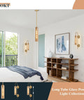 Amber Glass Wall Sconce With Brass Tube, 1 Light Modern Mid Century Vanity Fixture illuminating a bedroom.