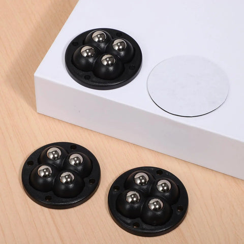 Swivel Caster Wheels 360 Degree Rotation Self Adhesive 12pcs Mini black wheels with stainless steel balls on wood surface.