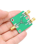 Built To Last Two Way RF Power Splitter PCB Board DC To Five Gigahertz Frequency Range With Six Decibel Attenuation held in hand.