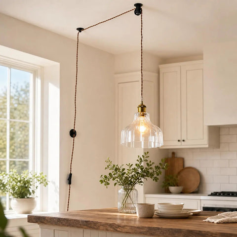 Fang Yan Mei Plug in Pendant Light with clear fluted glass shade hanging over a wooden kitchen island, featuring a plug in cord.