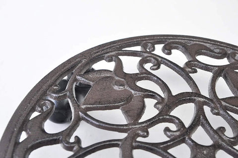 Close-up of the Heavy Duty Cast Iron Plant Stand On Wheels For Indoor And Outdoor Use, intricate cast iron design visible.