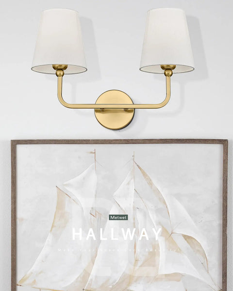 Gold Finish 2 Light Vanity Light Fixtures With Flared White Fabric Shade Modern Wall Sconces Above Nautical Art in Hallway