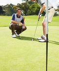 Two golfers using Wheel Like Golf Practice Ball With Adjustable Weight Putting Trainer And Instant Feedback To Improve Your Putting Stroke On The Green Build Confidence And Consistency on the green.