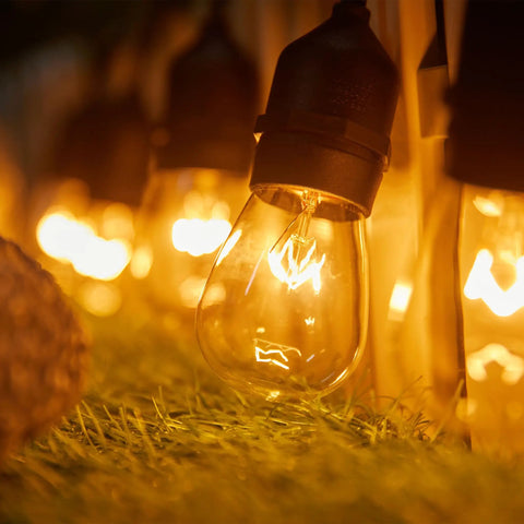 Bulk 20 Pack S14 Clear Light Bulbs 11W Warm Glow With E26 Medium Base For Indoor And Outdoor Use hanging on patio string