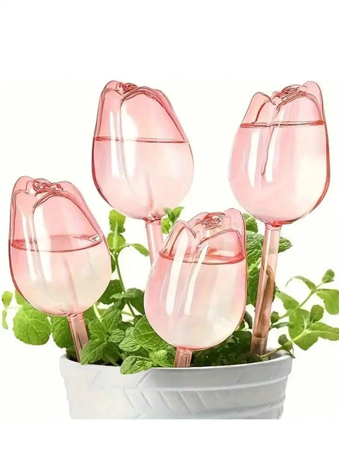 Pink Tulip Watering Globes For Indoor And Outdoor Plants Self Watering Bulbs That Slowly Release Water To Keep Pots Hydrated For 7 To 14 Days No Fuss Easy Care For Busy Plant Parents In A 2 Or 4 Pack, four pink tulip bulbs in a planter