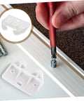 Screwdriver assembling 12 Piece Drawer Rail Replacement Kit with white plastic slides and guides for kitchen cabinets.