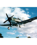 Vought F4U-4 Corsair Model Kit Navy Edition flying against a blue sky background