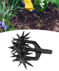 Rotary Garden Tiller And Soil Scarifier 2 In 1 Removable Handheld Aerator with black metal spikes shown against garden soil