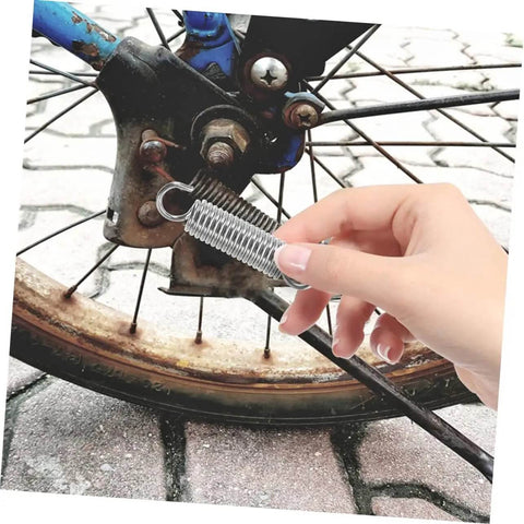 Eight Pieces Extended Compression Spring Assortment Kit For Electric Vehicle Stands Ladder Foot Supports With Heavy Duty Stainless Steel Build For Reliable Structure And Smooth Easy Use In Garage Or Home Projects, stainless steel coil spring held near bicycle wheel