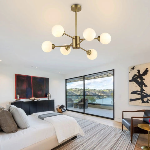 Six Light Sputnik Modern Pendant Chandelier With Opal White Glass Globes Height Adjustable in gold finish in bedroom setting