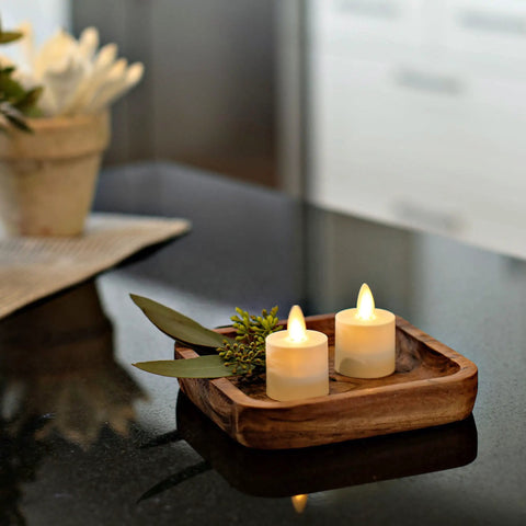 Flameless Flickering Tealights In Pearl Ivory Set Of 4 Realistic LED Flame Battery Operated Votive Candles on a wooden tray