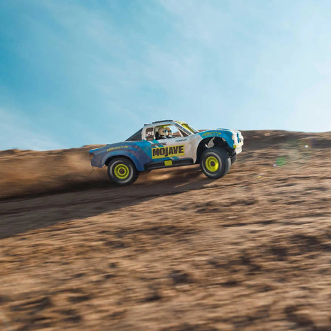 Grom 4x4 Desert RC Truck Ready To Run With Battery And Charger Included climbing sandy hill, blue and white Mojave style