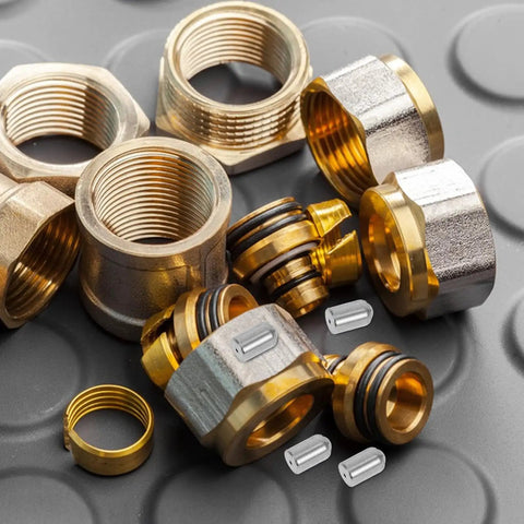 Assorted plumbing fittings and connectors on rubber mat, not 20 Pack Stainless Steel Ball Catch Door Hardware With Smooth Design
