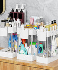 Super Slick 3 Pack Under Sink Organizer With Bonus Hanging Cups For Bathroom And Cabinet Storage, showcasing three white units filled with toiletries.