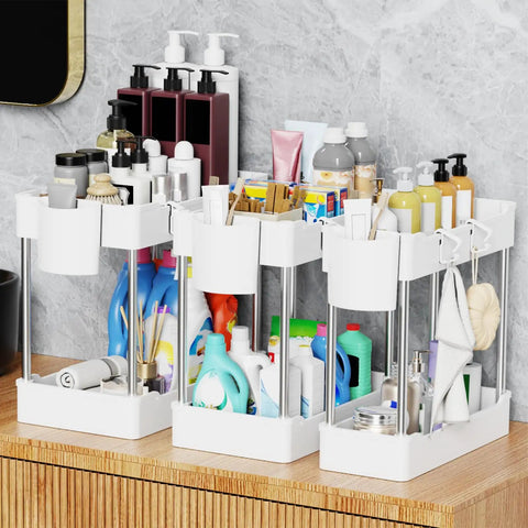 Super Slick 3 Pack Under Sink Organizer With Bonus Hanging Cups For Bathroom And Cabinet Storage, showcasing three white units filled with toiletries.