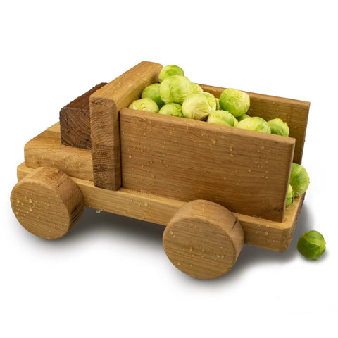Top Notch Food Safe Hard Wax Oil For Kitchen Countertops And Interior Woodwork Solvent Free Water Repellent Wood Finish Sealant in a wooden toy truck holding brussels sprouts.