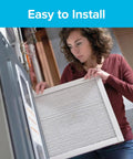 Woman installing 20x25x1 Air Filter MERV 14 MPR 2800 Dope Ultrafine Particle Capture For Home HVAC, pleated and electrostatic.