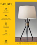 Benson Tripod Floor Lamp, 60 Inch Tall, Black With Antique Brass Accent, Drum Linen Shade, front view on table