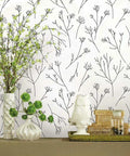 Green And White Twigs Peel And Stick Wallpaper Roll, 20.5 Inch Wide By 16.5 Feet Long displayed in a living room setting.