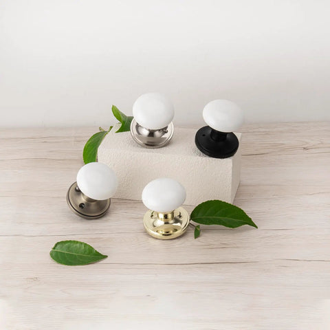 Porcelain White Door Knobs With Privacy Lock For Interior Doors, Antique Brass Ceramic Door Handles displayed on wooden surface