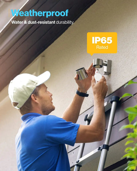 Man installing an Outdoor Dusk To Dawn A19 LED Bulb with Photocell Sensor, IP65 Waterproof, on exterior wall using a ladder