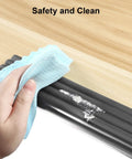Female hand cleaning Tot Safe Edge Corner Protectors 16 Foot Ultra Plush Foam Bumpers With Rock Solid Adhesive for sharp tables.