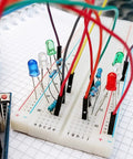 Breadboard with LEDs and resistors connected using 140 Piece Breadboard Jumper Wire Kit With 14 Lengths Of Assorted Color Cables
