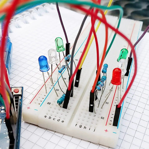 Breadboard with LEDs and resistors connected using 140 Piece Breadboard Jumper Wire Kit With 14 Lengths Of Assorted Color Cables
