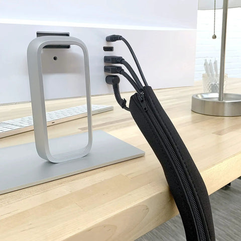 Zippered Cable Sleeve 24x4 Inches, 4-Pack Black, installed on desk setup hiding and covering wires with simple zip design