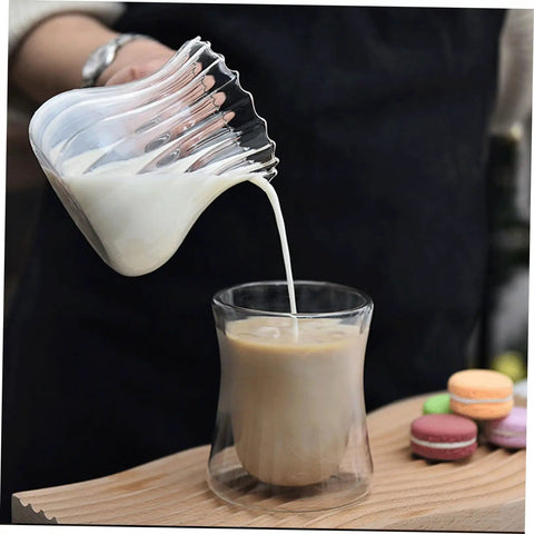 Glass Creamer Pitcher With Spout For Turkish Coffee And Espresso pouring milk into cup, elegant design for home barista vibes.