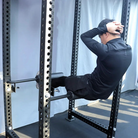 Person using Single Leg Squat Roller Attachment for Power Rack and Home Gym, Nordic Curls Kit for leg exercise