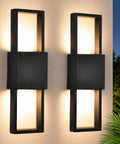 Modern Outdoor Wall Sconce 2 Pack, Up Down LED Light, 3000K, Hardwired, slim black frame with warm light on wall.