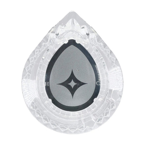 Clear teardrop-shaped crystal award with engraved star pattern, viewed from above.
