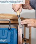 User sharpening a chisel using Heavy Duty Workhorse 150W Water Cooled Bench Sharpener with leather wheel for perfect edges.