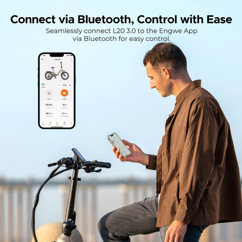 Man connecting L20 3.0 Electric Bike For Adults With App IoT Anti Theft via Bluetooth using a smartphone, bike handlebars visible