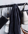 Tough As Nails Wall Mounted Coat Hooks With Slick Black Finish For Heavy Duty Closet And Bathroom Storage Game Changer Space Saving Rack with a jacket, bag, and umbrella.
