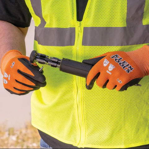 Person wearing Rugged Knit Dipped Work Gloves With Nitrile Coating For Cut Resistance ANSI A1 Touchscreen Compatible Nylon Spandex Fit Snug And Flexible Grippy Grip X Large Two Pack For Everyday Jobs using a tool.