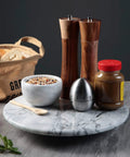 12 Inch Solid Marble Lazy Susan Turntable with spices and condiments for kitchen countertop organization.