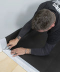 Applying Straight Shooter Floor Underlayment for Laminate and Engineered Wood, 600 square foot roll, with precise cutting.
