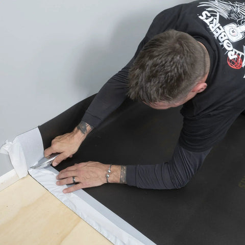 Applying Straight Shooter Floor Underlayment for Laminate and Engineered Wood, 600 square foot roll, with precise cutting.