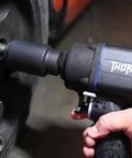 Professional 1/2 Inch Impact Wrench Featuring Generation 2 Thor Model close-up view with user, showcasing grip and anvil for metal work.